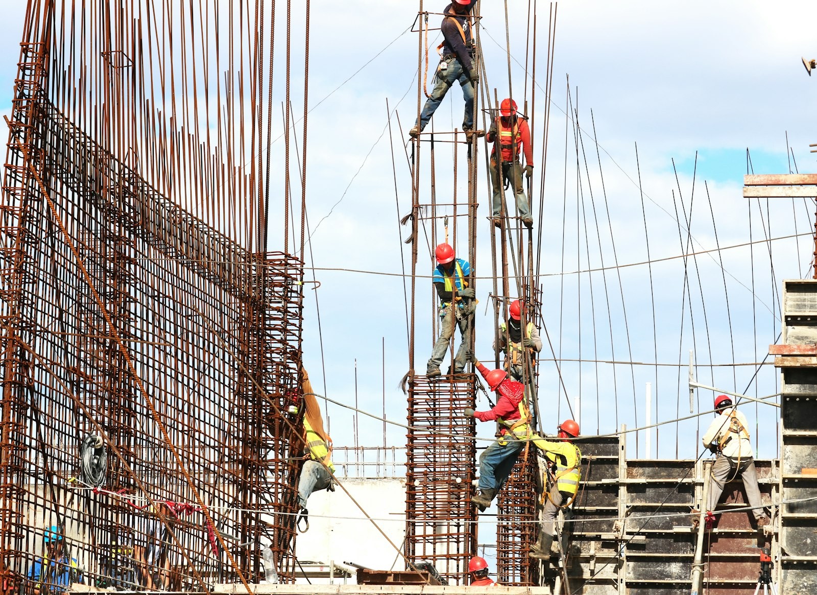 Union ironworkers tying rebar cages on high-rise column