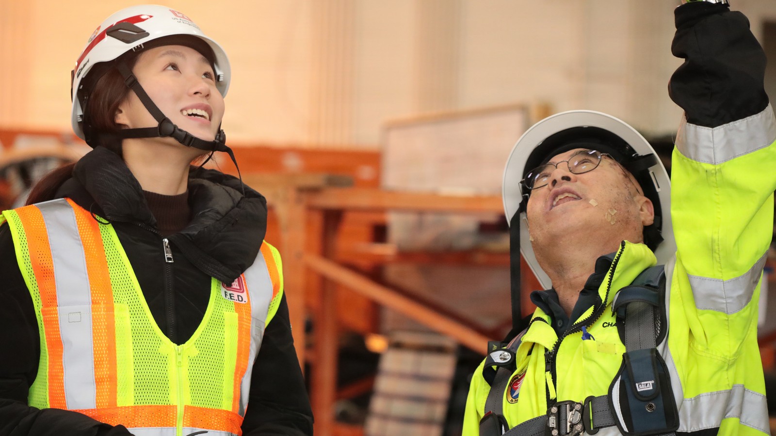 Licensed structural engineers conducting overhead beam torque inspection